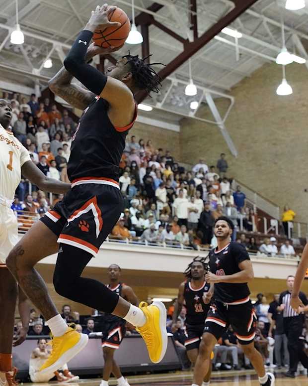 Nov 29, 2021; Austin, Texas, USA; Sam Houston State Bearkats forward Tristan Ikpe (12) shoots over Texas Longhorns guards Courtney Ramey (3) and Andrew Jones (1) during the first half at Gregory Gymnasium. Mandatory Credit: Scott Wachter-USA TODAY Sports
